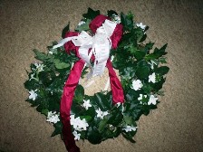 wreath with stephenotis, ivy, and a broad leaf that we cant identify :)